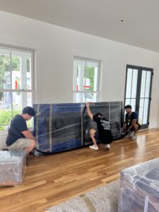 Three Elite Haulerz Movers moving a table