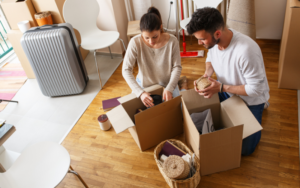 People packing items into their moving boxes